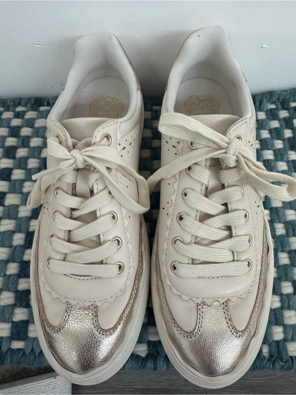 Vince Camuto cream leather sneakers with metallic gold .